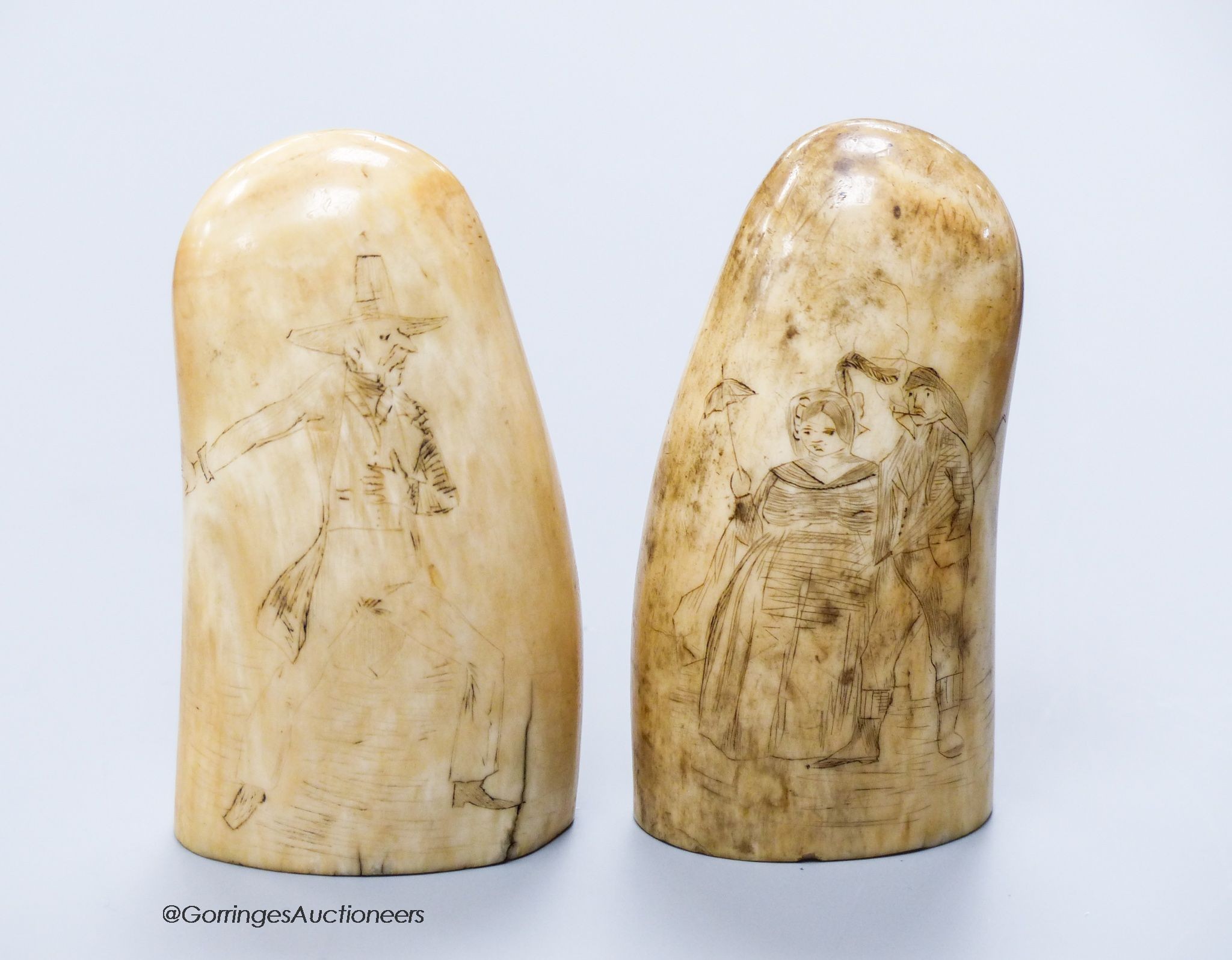 Two 19th century scrimshaw sperm whale teeth, engraved with Victorian figures, height 10cm